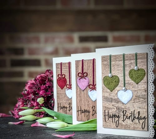 Handcrafted 5x7 birthday card with natural wool filled hearts on rustic wood background