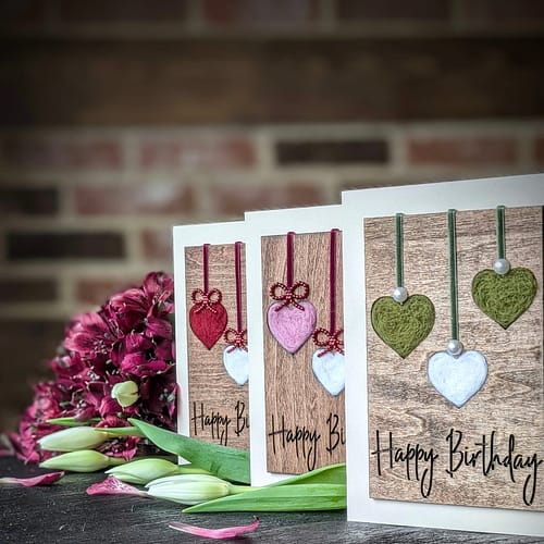 Handcrafted 5x7 birthday card with natural wool filled hearts on rustic wood background