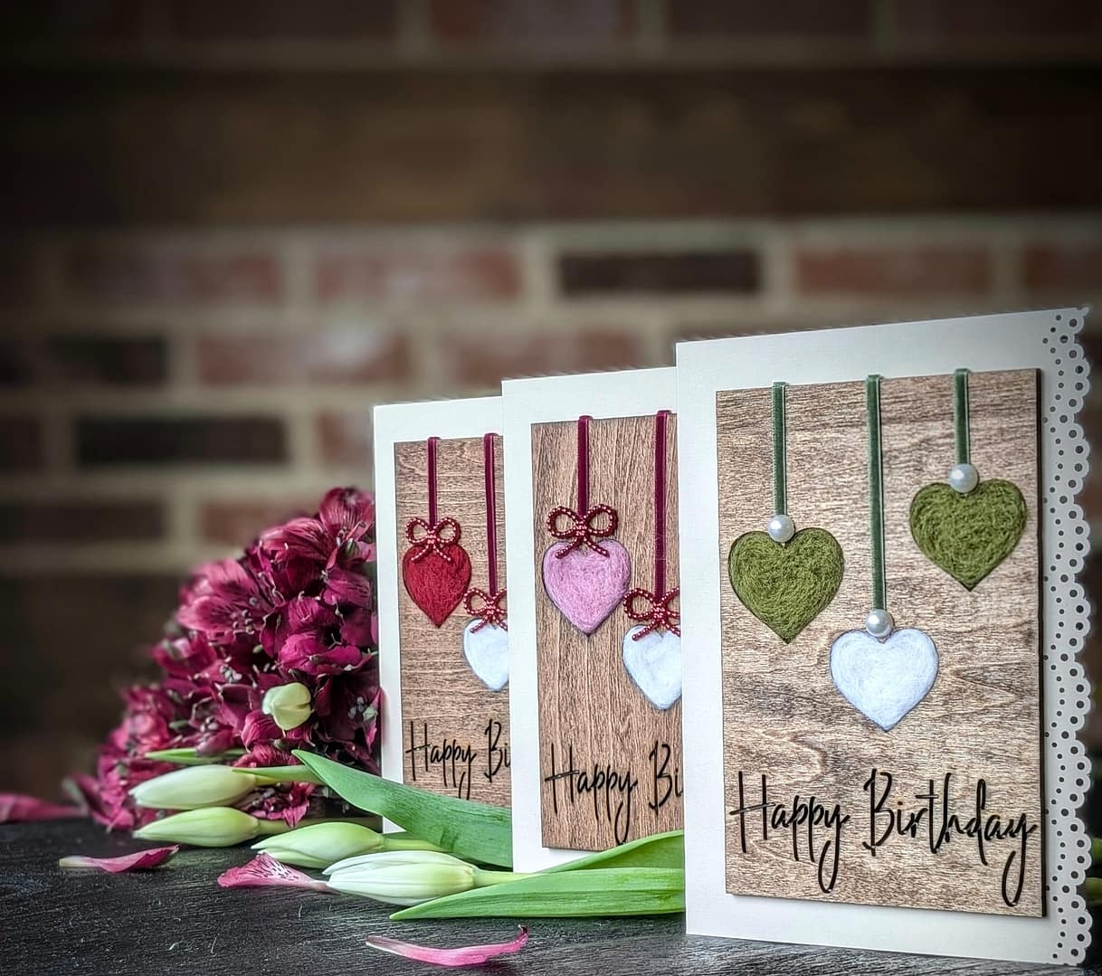 Handcrafted 5x7 birthday card with natural wool filled hearts on rustic wood background