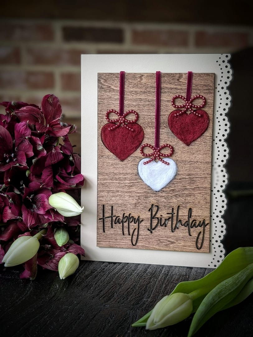 Handcrafted 5x7 birthday card with natural wool filled hearts on rustic wood background